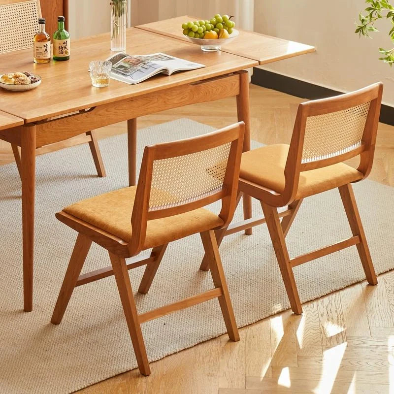 Rattan Dining Chairs Set of 2 placed around a Wood Dining Table