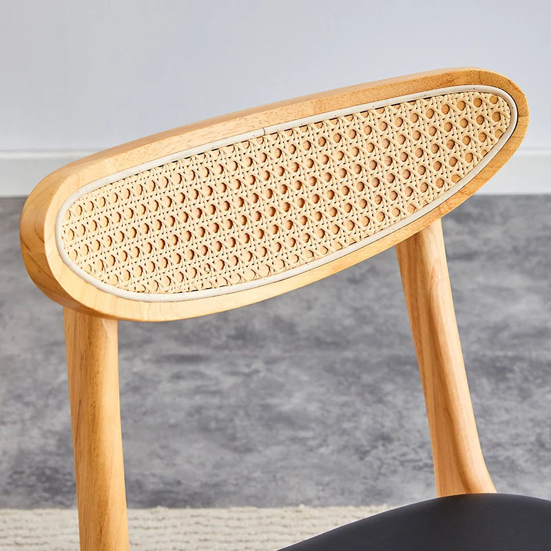 Front view of wood dining chair showing its curved ergonomic backrest