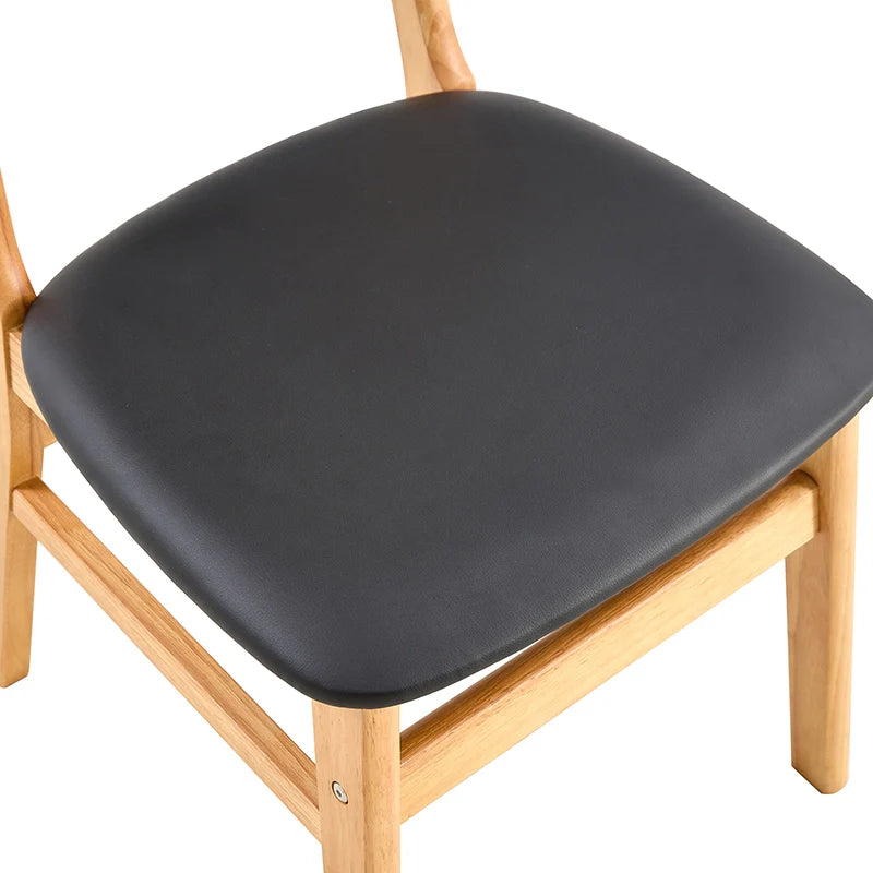 Solid wood dining chair showing its comfortable leather cushioned seat.