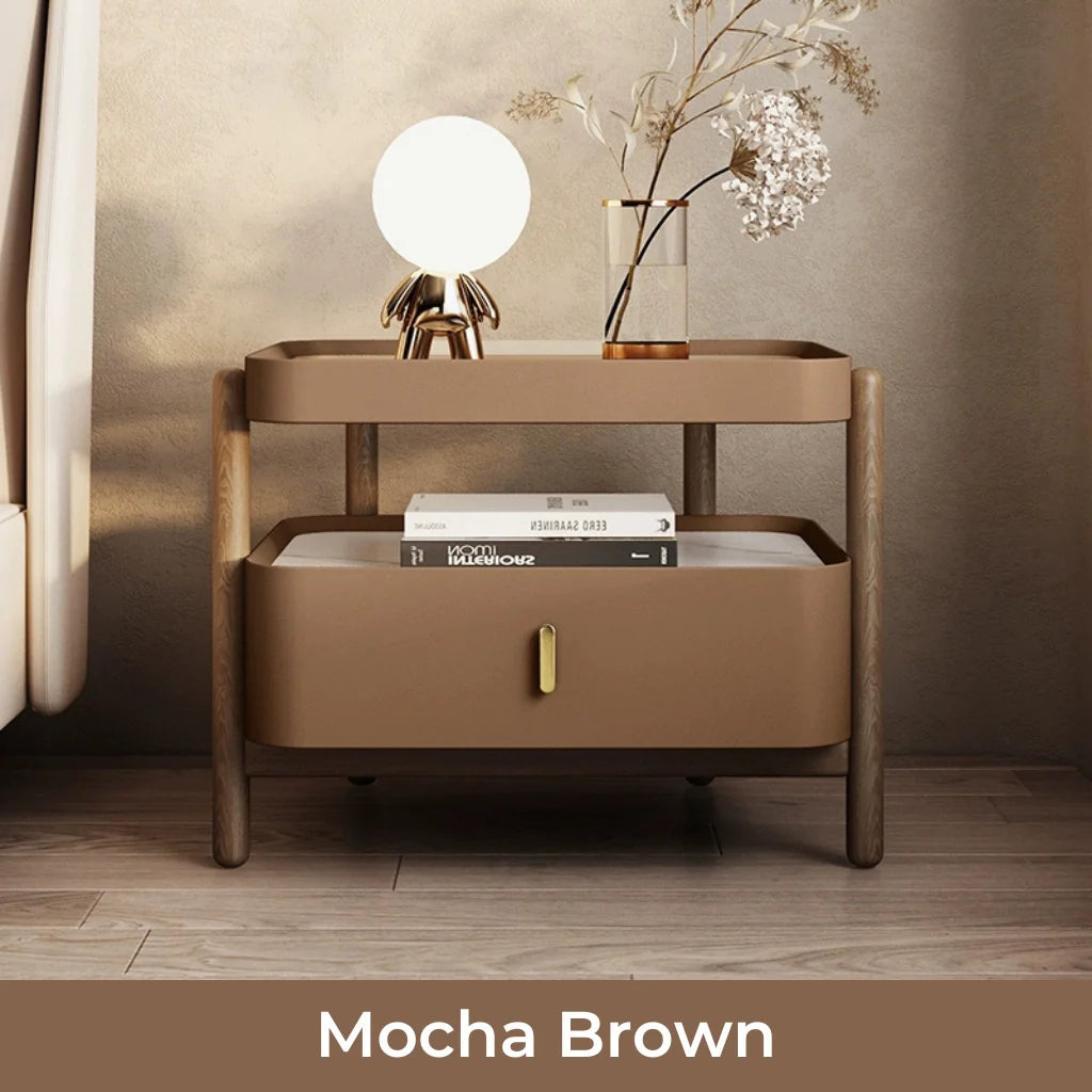 An image of a brown nightstand with a modern design featuring a sintered stone and glass top, a solid pine wood frame, a glossy lacquer drawer, and an open shelf for versatile storage, available in Alabaster Cream, Mocha Brown, Olive Sage, and Chestnut Bronze finishes.