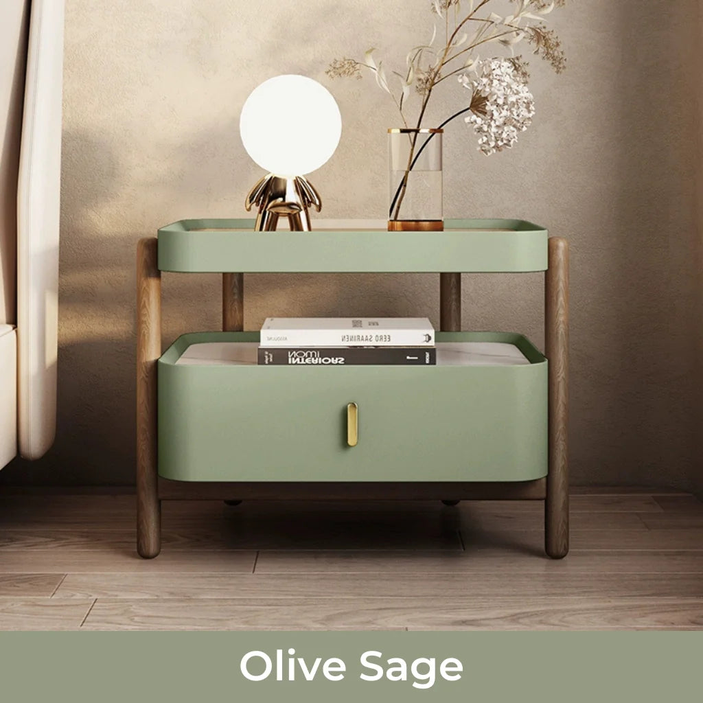 An image of a green nightstand with a modern design featuring a sintered stone and glass top, a solid pine wood frame, a glossy lacquer drawer, and an open shelf for versatile storage, available in Alabaster Cream, Mocha Brown, Olive Sage, and Chestnut Bronze finishes.