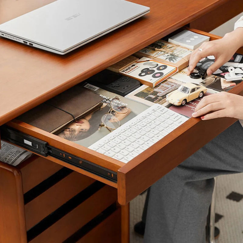 Convenient small built in drawer of wood and metal desk housing some office space essentials