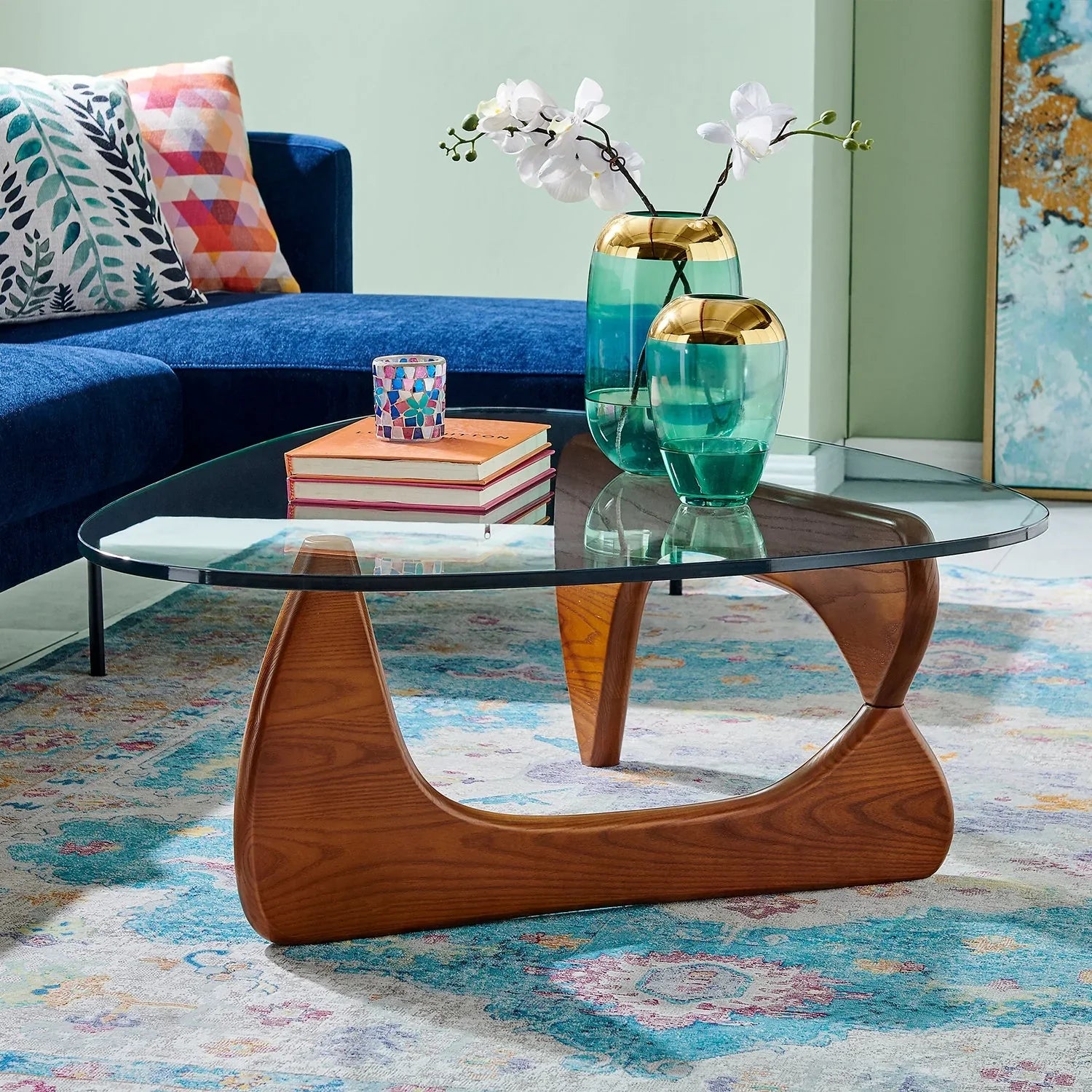 Glass and wood coffee table with brown base complementing blue interior