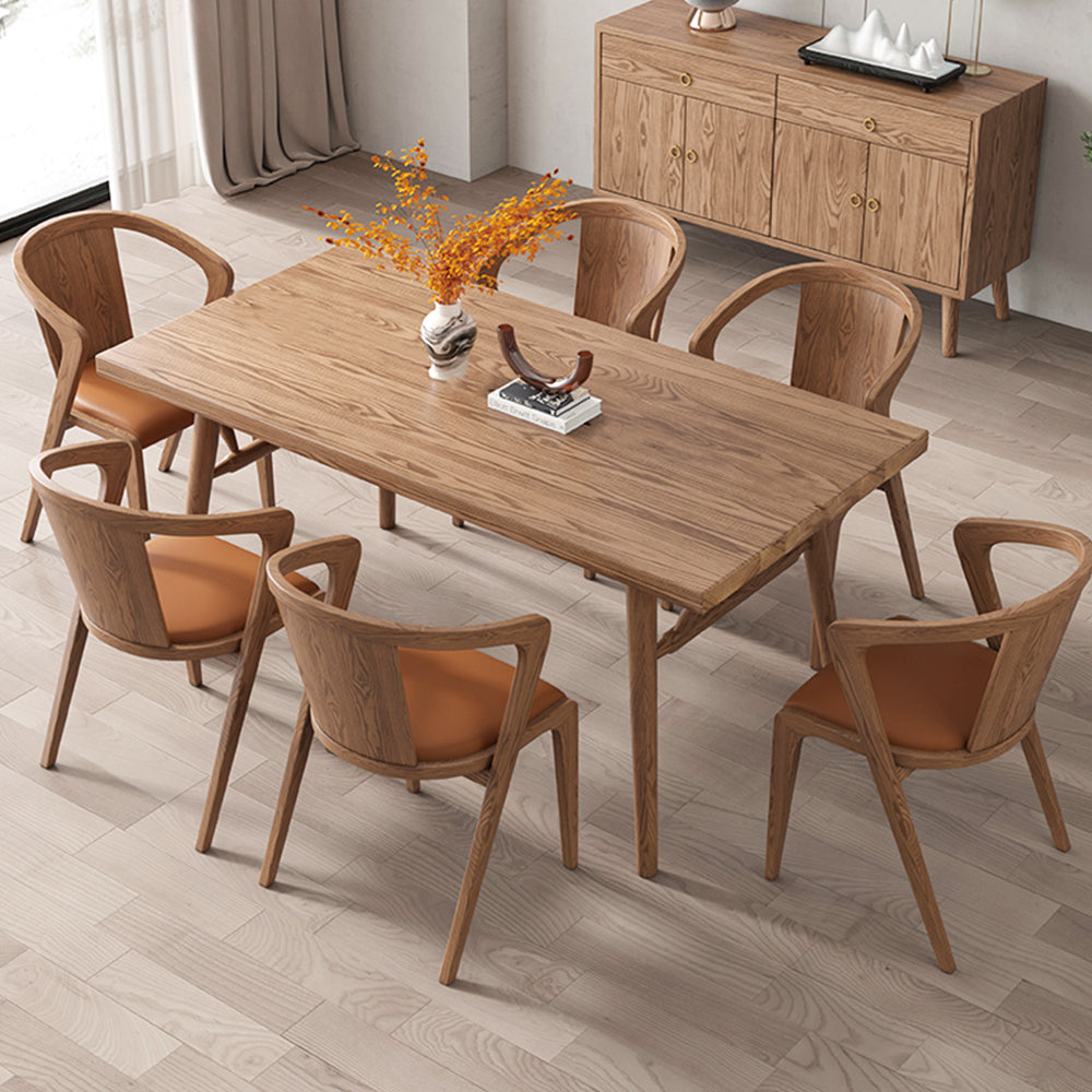 Wooden Dining Table elegantly occupying a dining space surrounded by stunning armed dining chairs