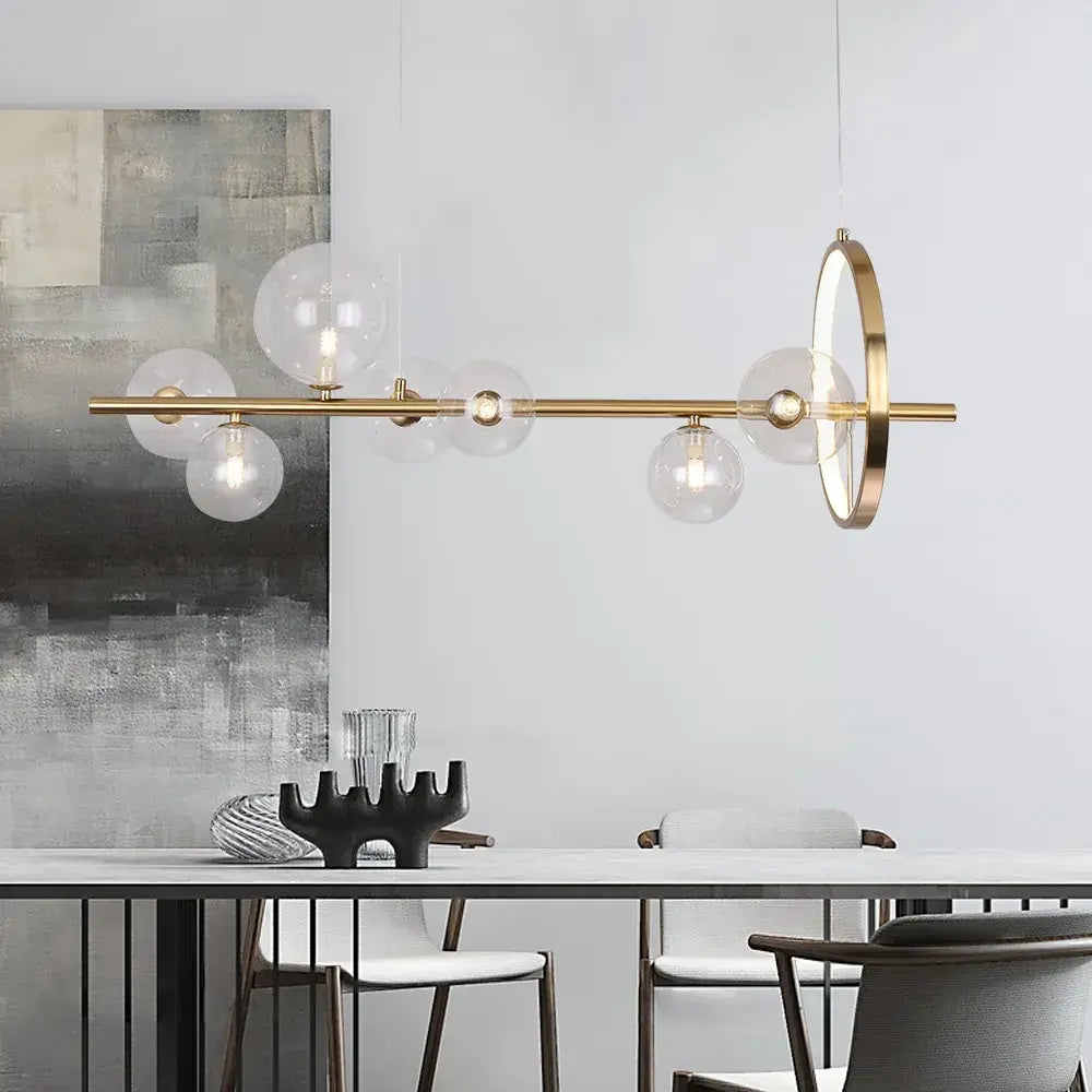 a kitchen island chandelier over a dining table in a modern setting