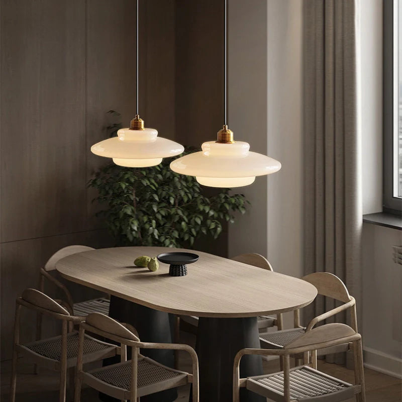 a kitchen island pendant light over a dining table