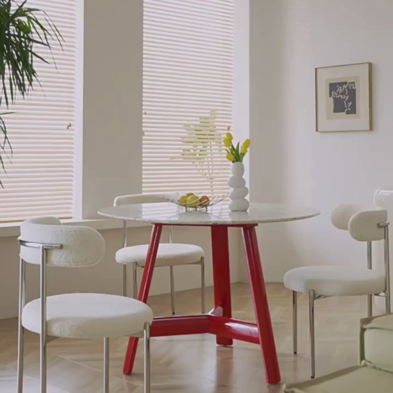 a wood dining table with 3 matching dining chairs in a modern setting