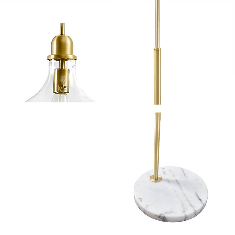 Up close image of modern arc floor lamp highlihting light socket, gold metal stand and marble base