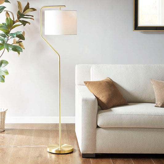 a modern gold floor lamp with drum-shaped shade and angular arched metal