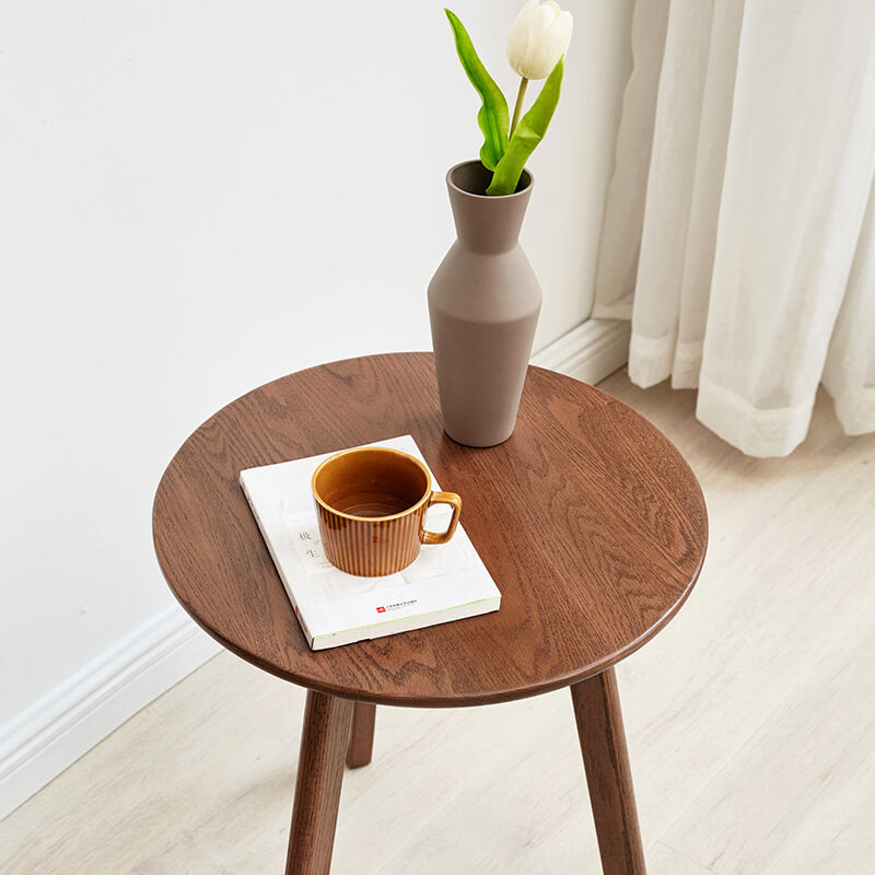 a round wood end table showcasing the smooth table-top