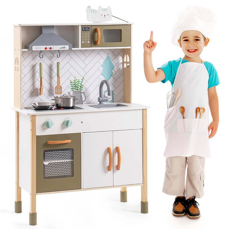 A boy with the wooden kitchen playset