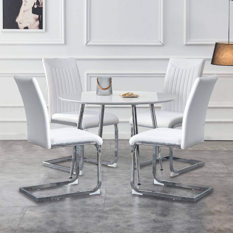 round white table with white chairs in a living room