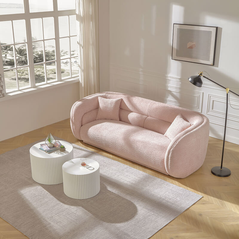 Pink  round sofa in a living room with two coffee table 